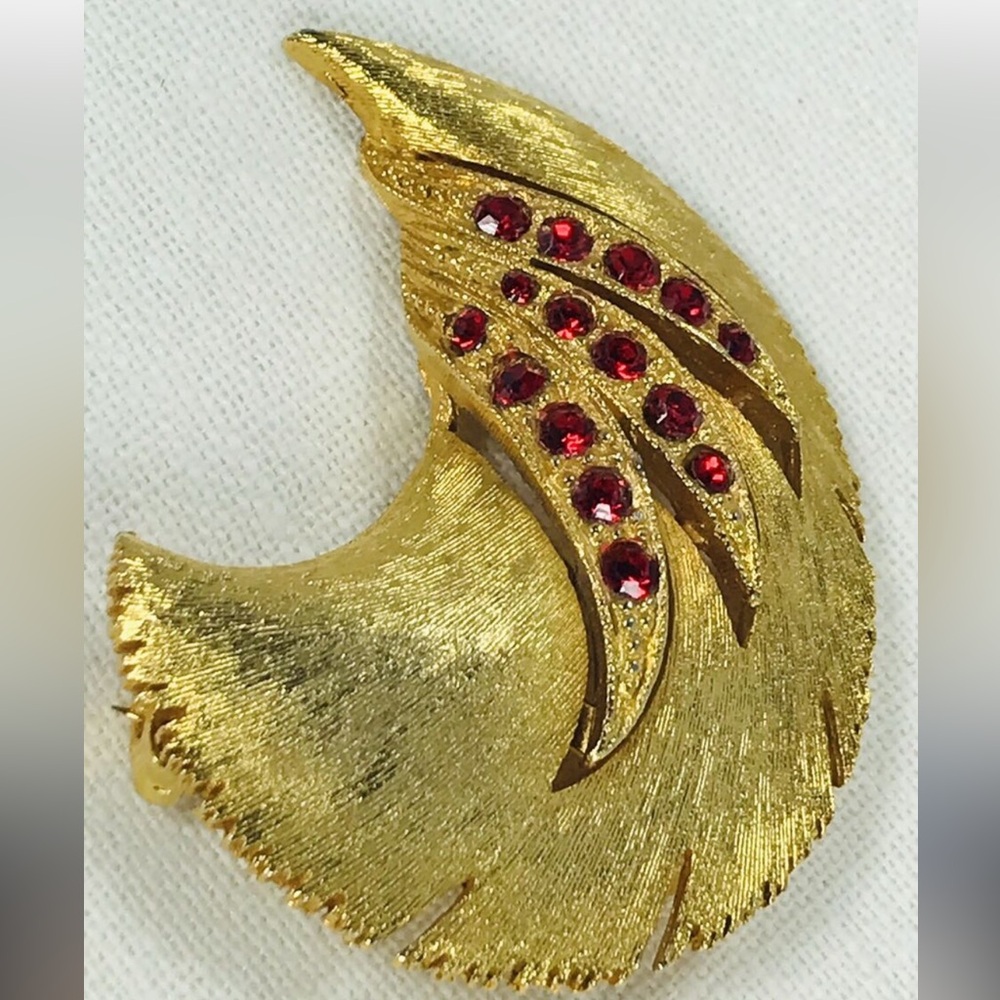 Elegant Gold Brooch with Red Accents